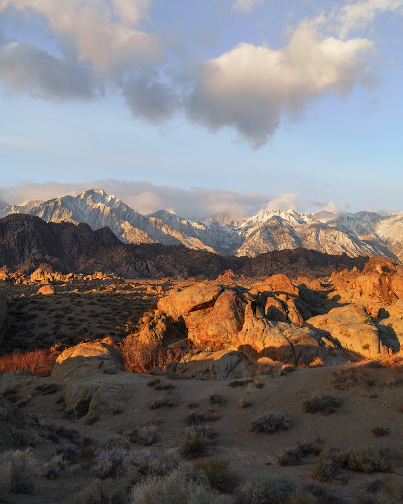 Breathtaking view of the Sierra Nevada mountains at dawn in Lone Pine, CA, showcasing rugged terrain and sunrise-lit peaks.